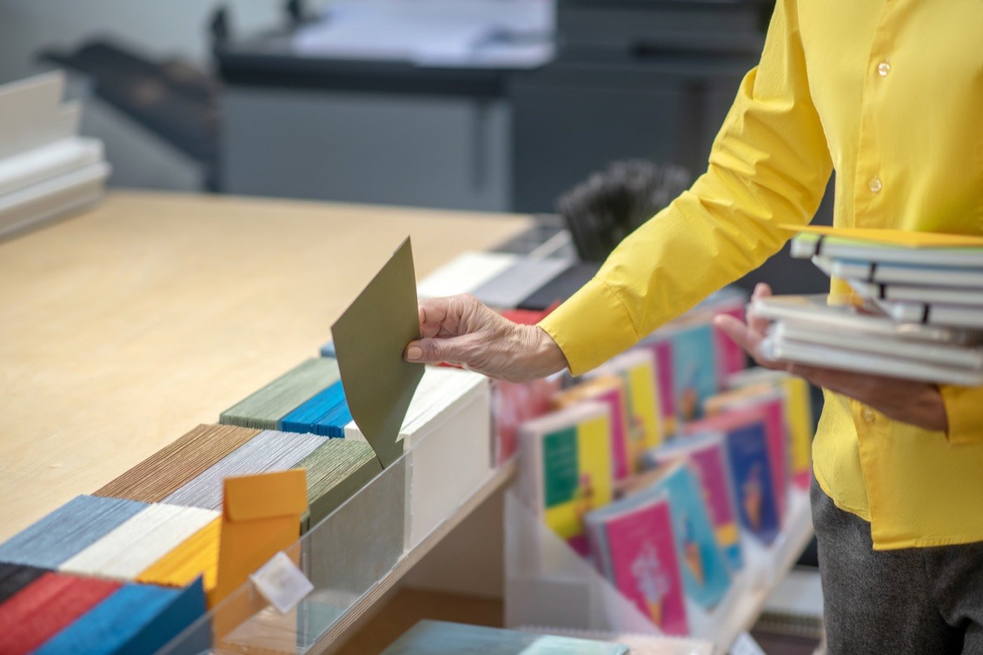 Warehouse worker checking printed sheets for quality